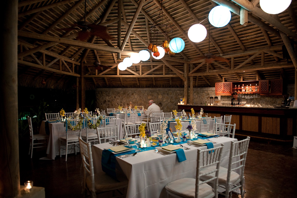 Blue glass votive holders and blue white paper lanterns complete the look
