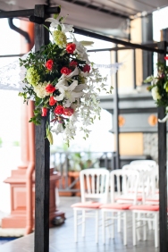 white and coral chuppah flowers